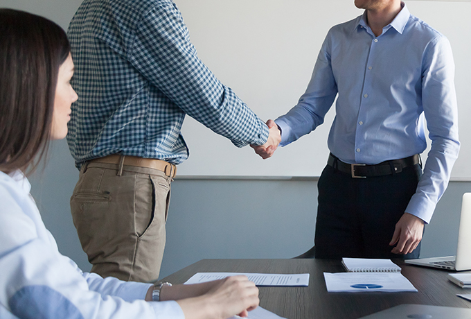 Work colleagues shaking hands