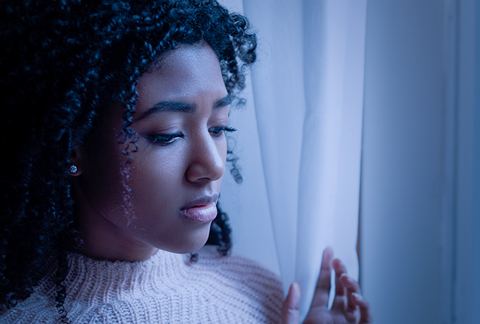 Grieving woman looking out a window